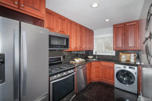 a kitchen with a stove a microwave and cabinets