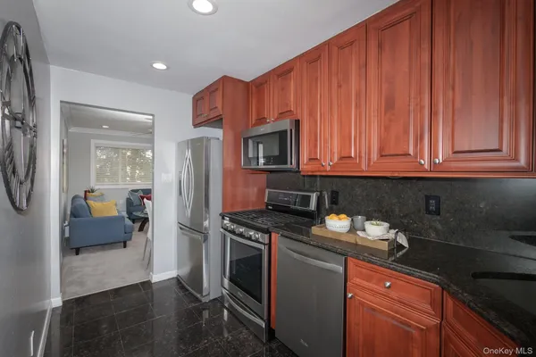 a kitchen with stainless steel appliances wooden cabinets and a stove top oven