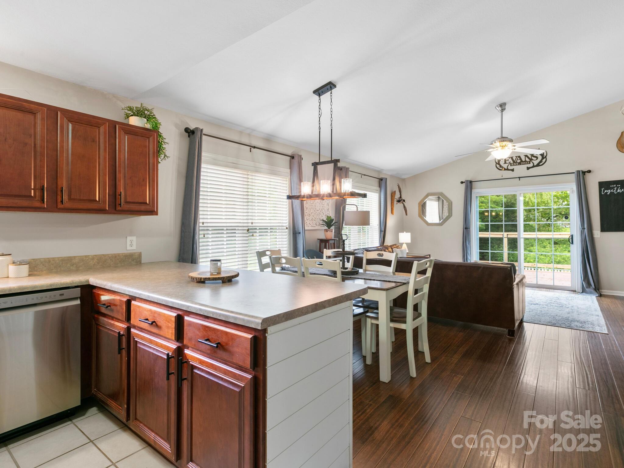 61 Village Street Clyde, NC 28721 - Photo 11 of 30 a kitchen with a table chairs stove and wooden floor