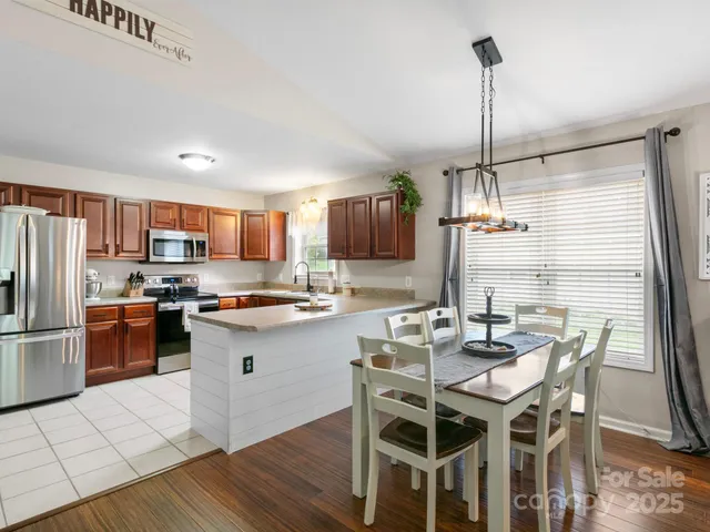a kitchen with kitchen island a refrigerator and a wooden cabinets