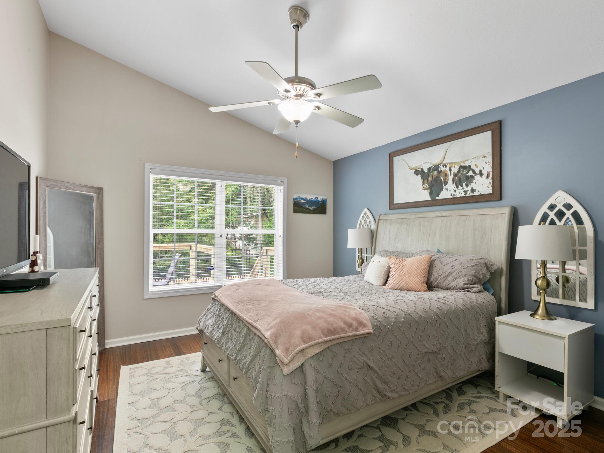 61 Village Street Clyde, NC 28721 - Photo 15 of 30 a bedroom with a bed and a chandelier