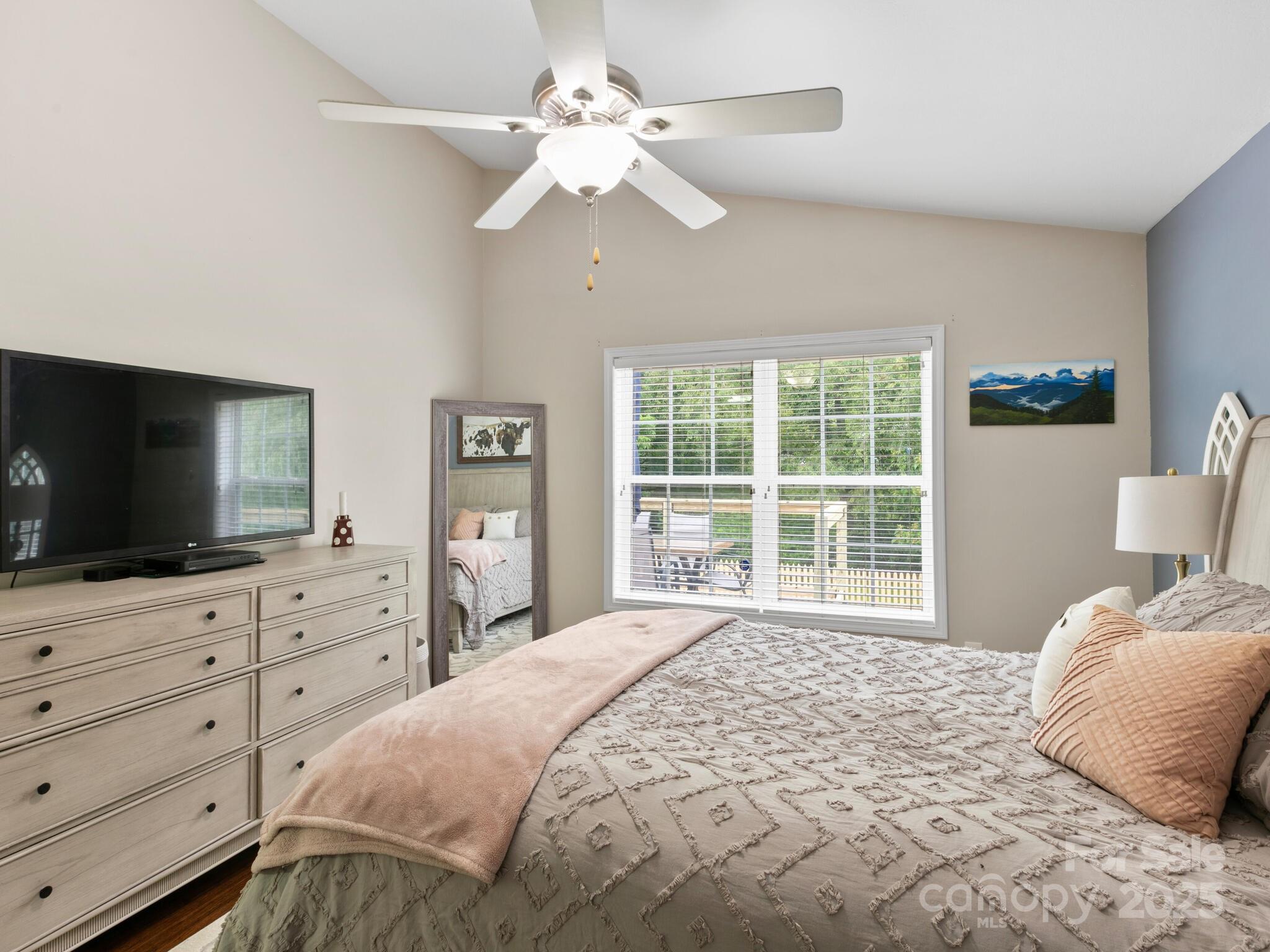 61 Village Street Clyde, NC 28721 - Photo 16 of 30 a bedroom with a large bed and a flat screen tv