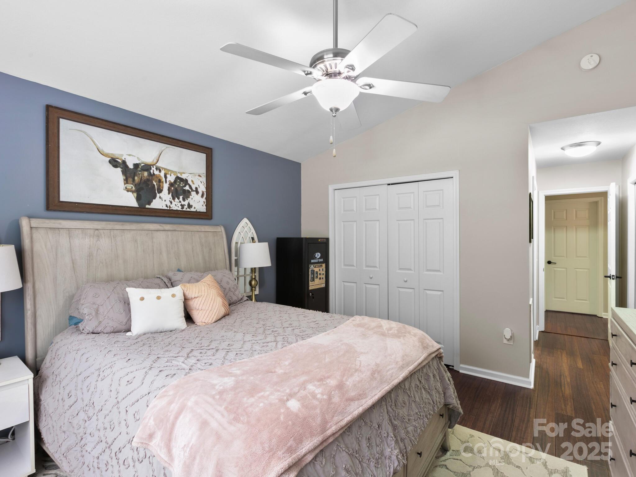 61 Village Street Clyde, NC 28721 - Photo 17 of 30 a bedroom with a large bed and a chandelier