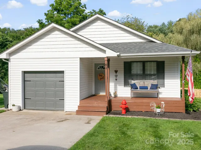a front view of a house with a yard and porch