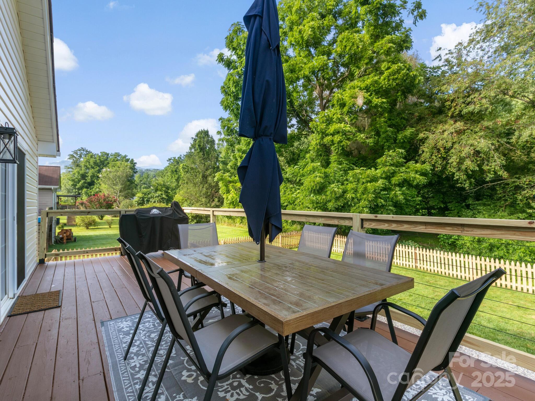 61 Village Street Clyde, NC 28721 - Photo 24 of 30 a balcony with wooden floor table and chairs