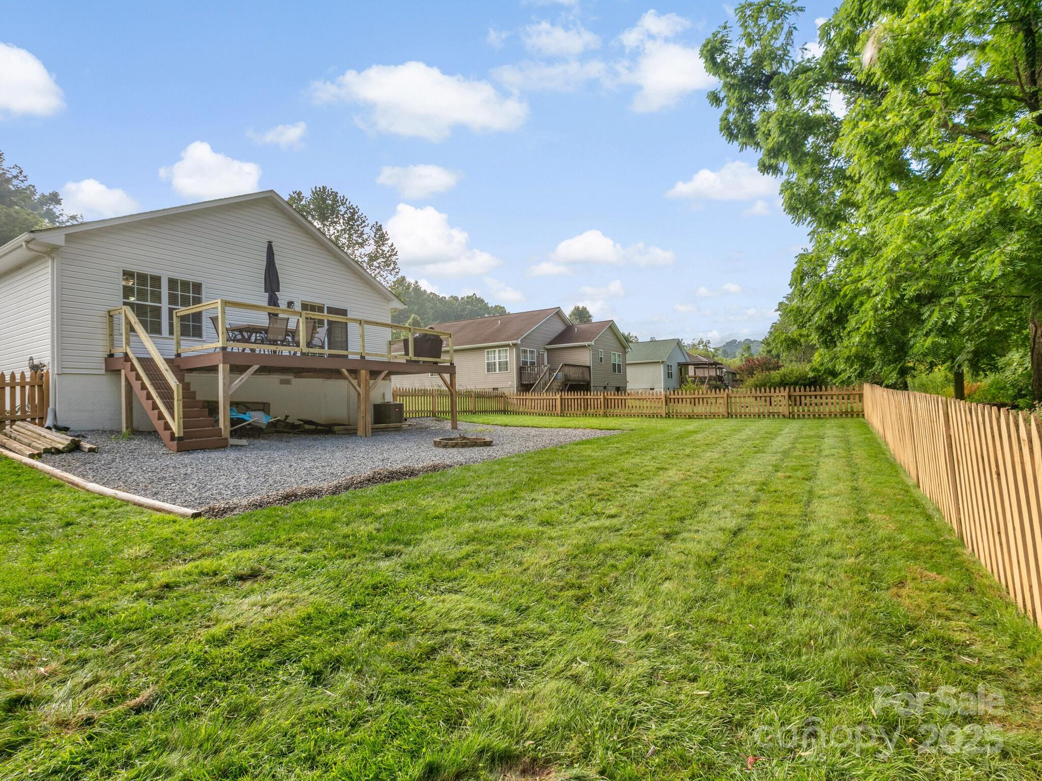 61 Village Street Clyde, NC 28721 - Photo 27 of 30 a view of a house with backyard porch and sitting area