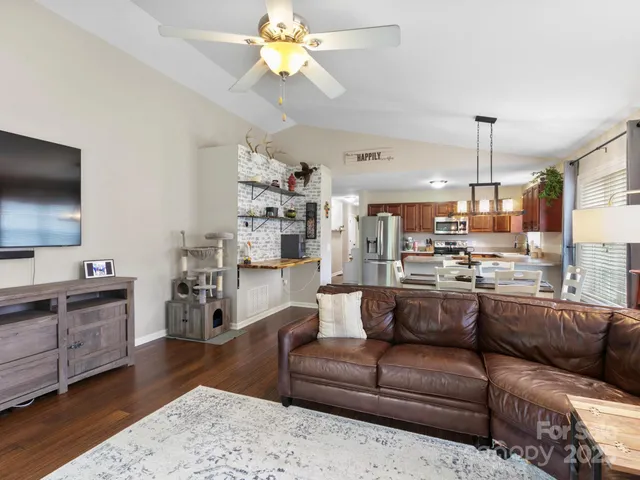 a view of a living room kitchen and a wooden floor