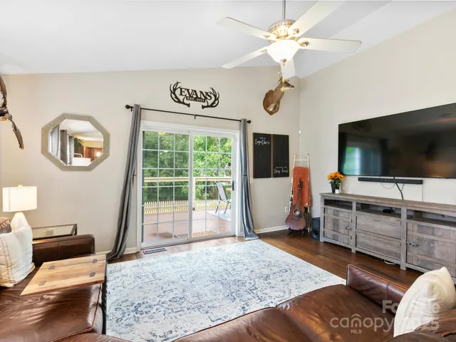 a living room with furniture and flat screen tv