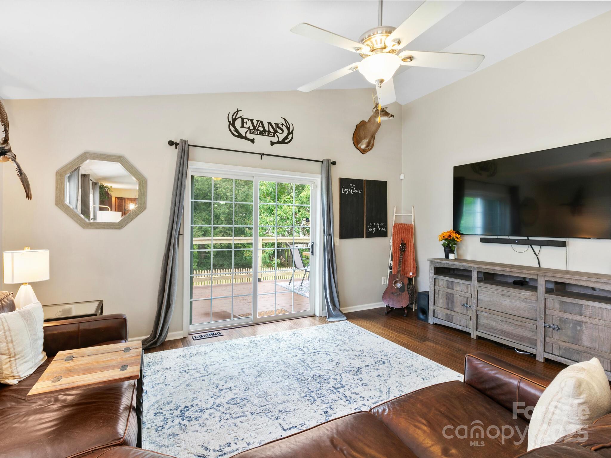 61 Village Street Clyde, NC 28721 - Photo 8 of 30 a living room with furniture and flat screen tv