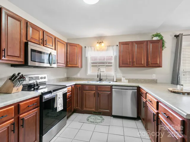 a kitchen with a sink stove top oven and cabinets