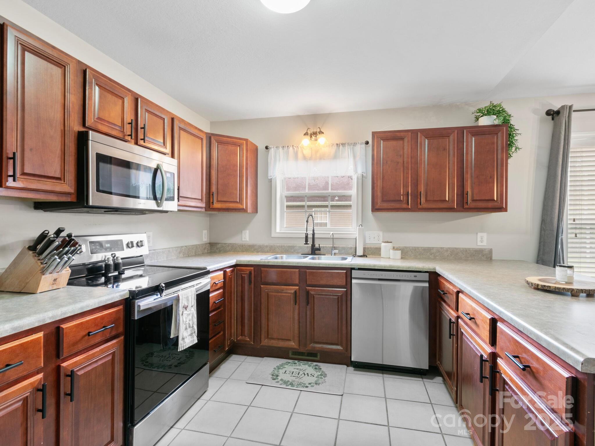 61 Village Street Clyde, NC 28721 - Photo 9 of 30 a kitchen with a sink stove top oven and cabinets