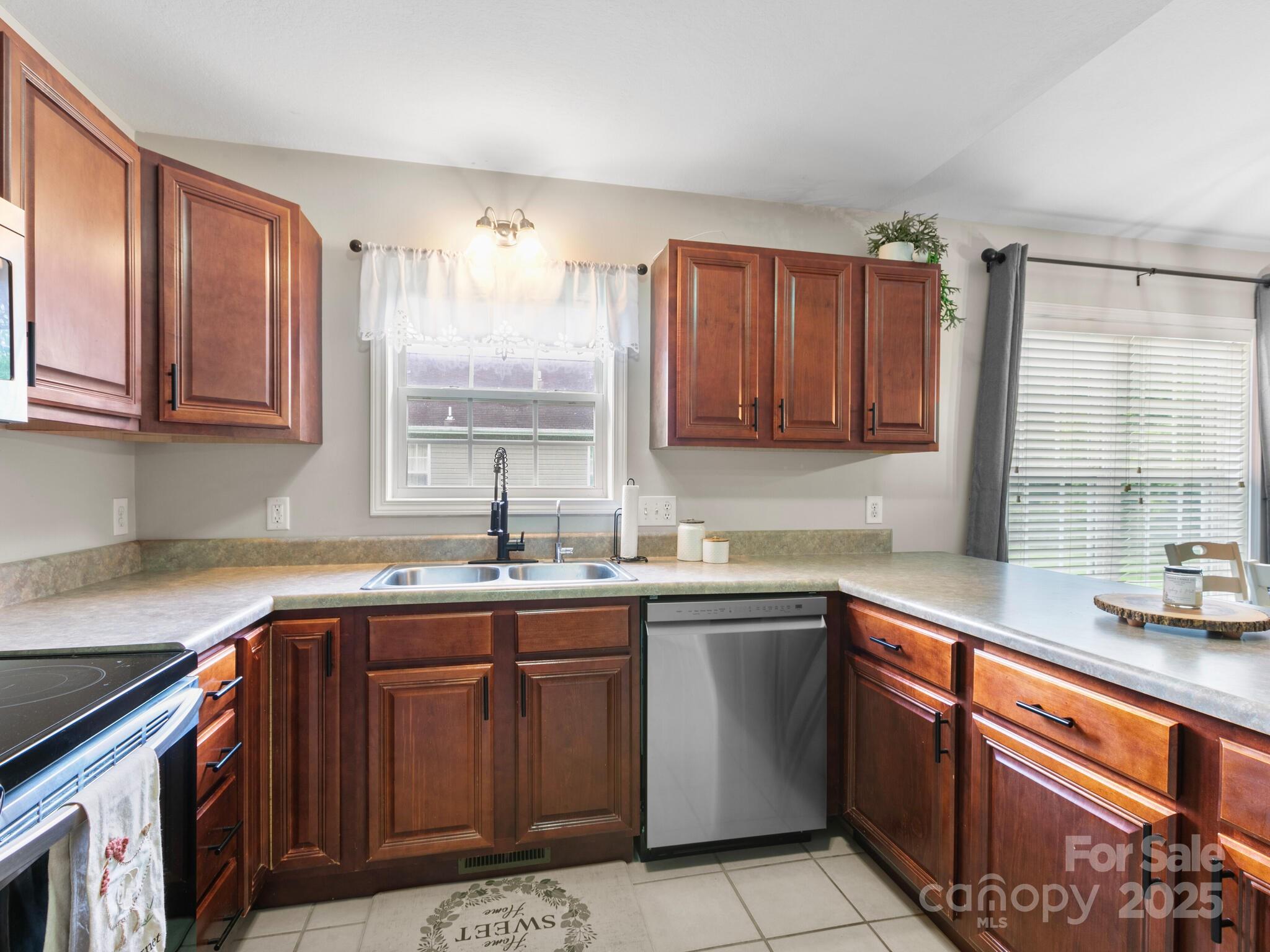 61 Village Street Clyde, NC 28721 - Photo 10 of 30 a kitchen with a sink stove and cabinets