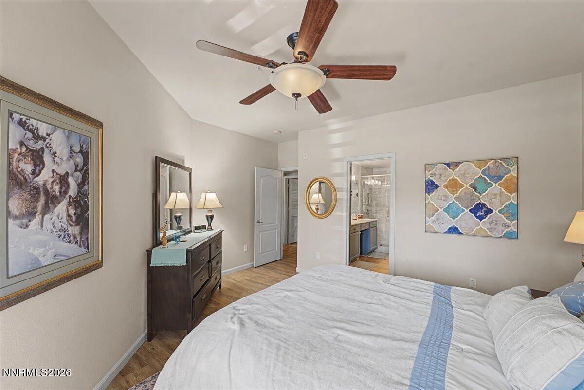 17000 Wedge Parkway, Unit 2625 Reno, NV 89511 - Photo 4 of 42 a bedroom with a large bed and a chandelier