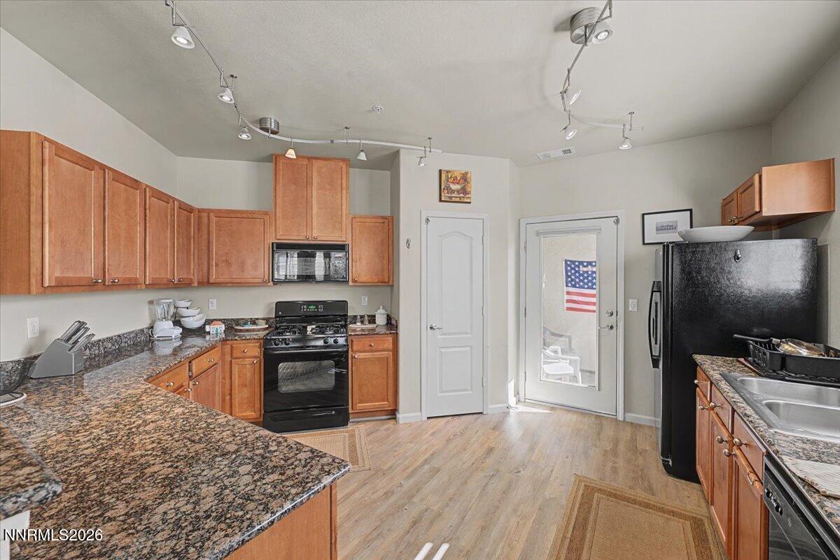 17000 Wedge Parkway, Unit 2625 Reno, NV 89511 - Photo 9 of 42 a kitchen with granite countertop a stove sink and refrigerator