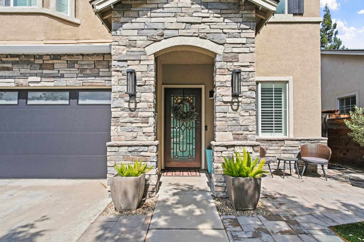 261 Greenhouse Way Turlock, CA 95382 - Photo 1 of 1 a front view of a house with outdoor seating
