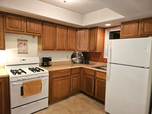 a kitchen with a stove sink and refrigerator