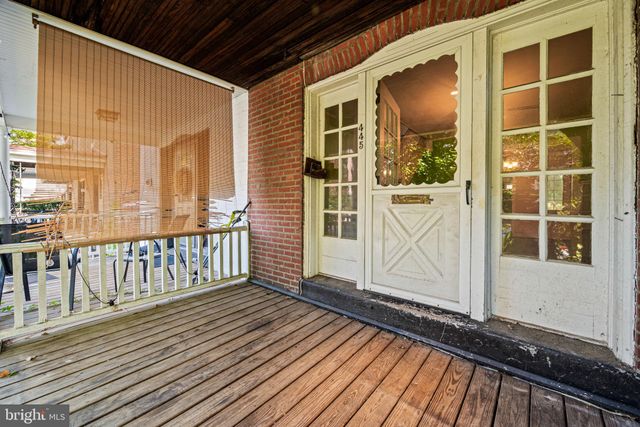 a view of a balcony with wooden floor and fence