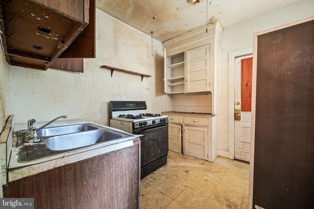 a kitchen with stainless steel appliances granite countertop a stove and a microwave