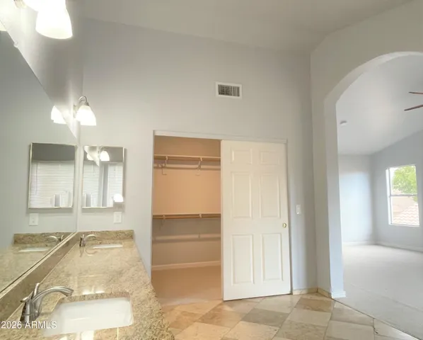 a bathroom with a tub sink and mirror