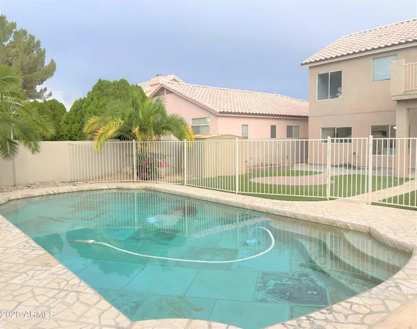 a view of a swimming pool with a backyard
