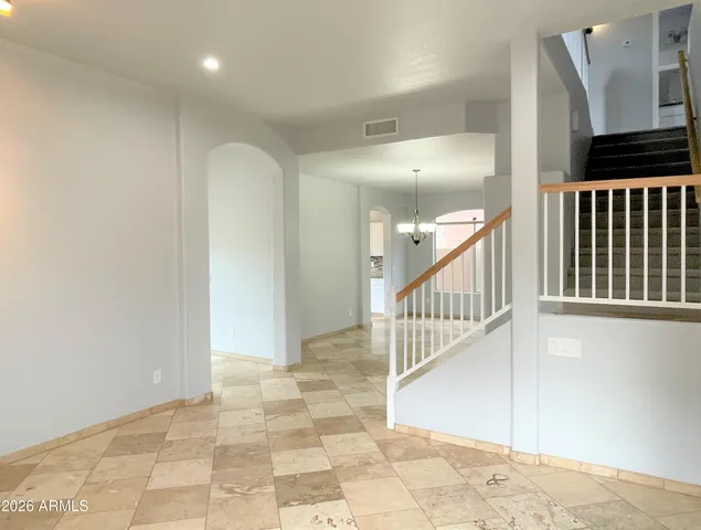 a view of a hallway with entryway and stairs