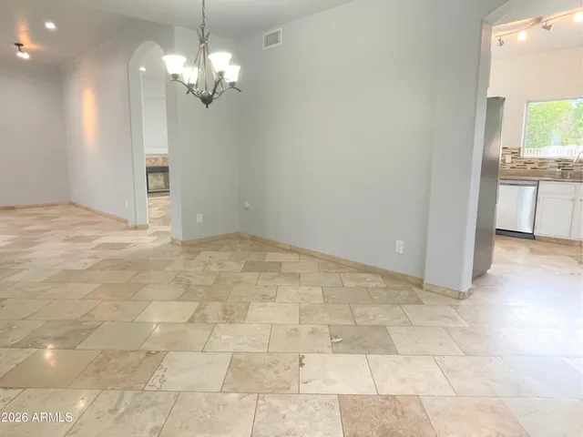 a view of a kitchen with a sink and a chandelier in a room