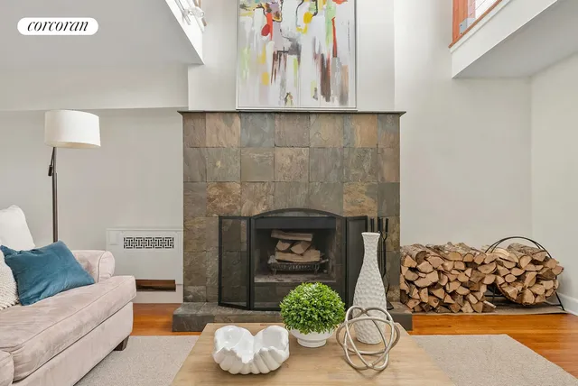 a living room with furniture a flat screen tv and floor to ceiling window