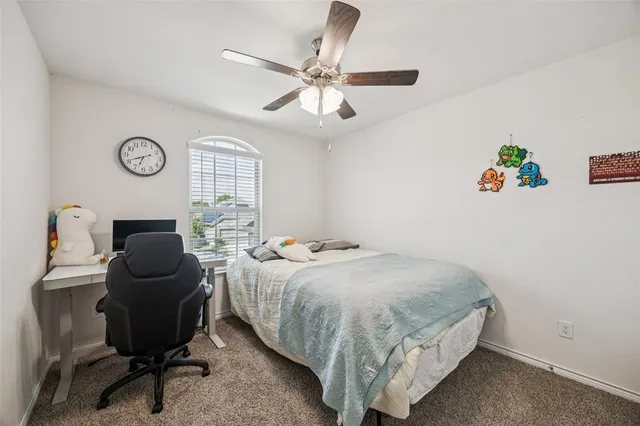 a bedroom with a bed and a chair