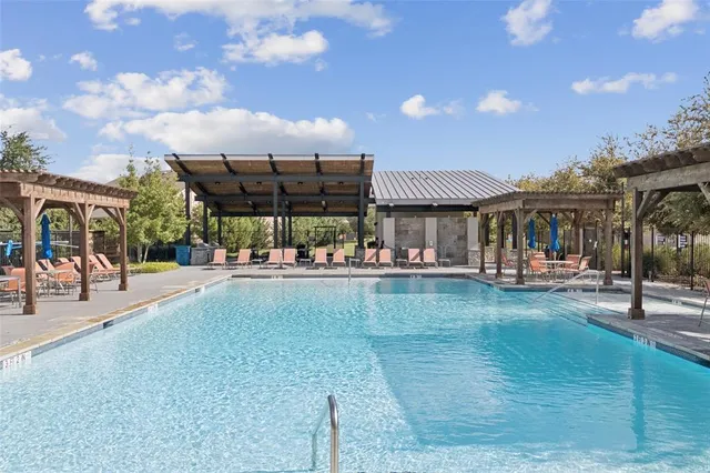a view of a swimming pool with outdoor seating
