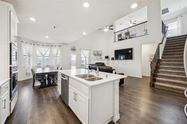 a kitchen with a sink and a stove top oven