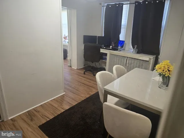 a dining room with furniture and wooden floor