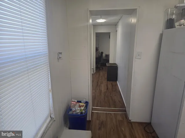 a view of a hallway and a dining room with furniture