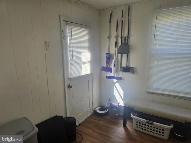 a view of hallway with windows and wooden floor