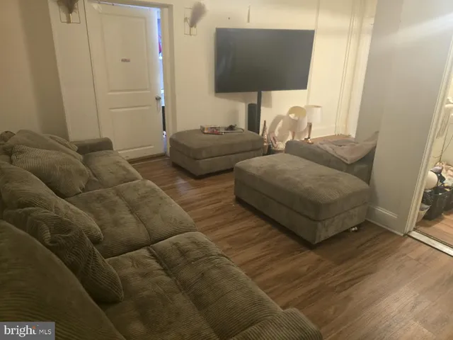 a living room with furniture and a lamp