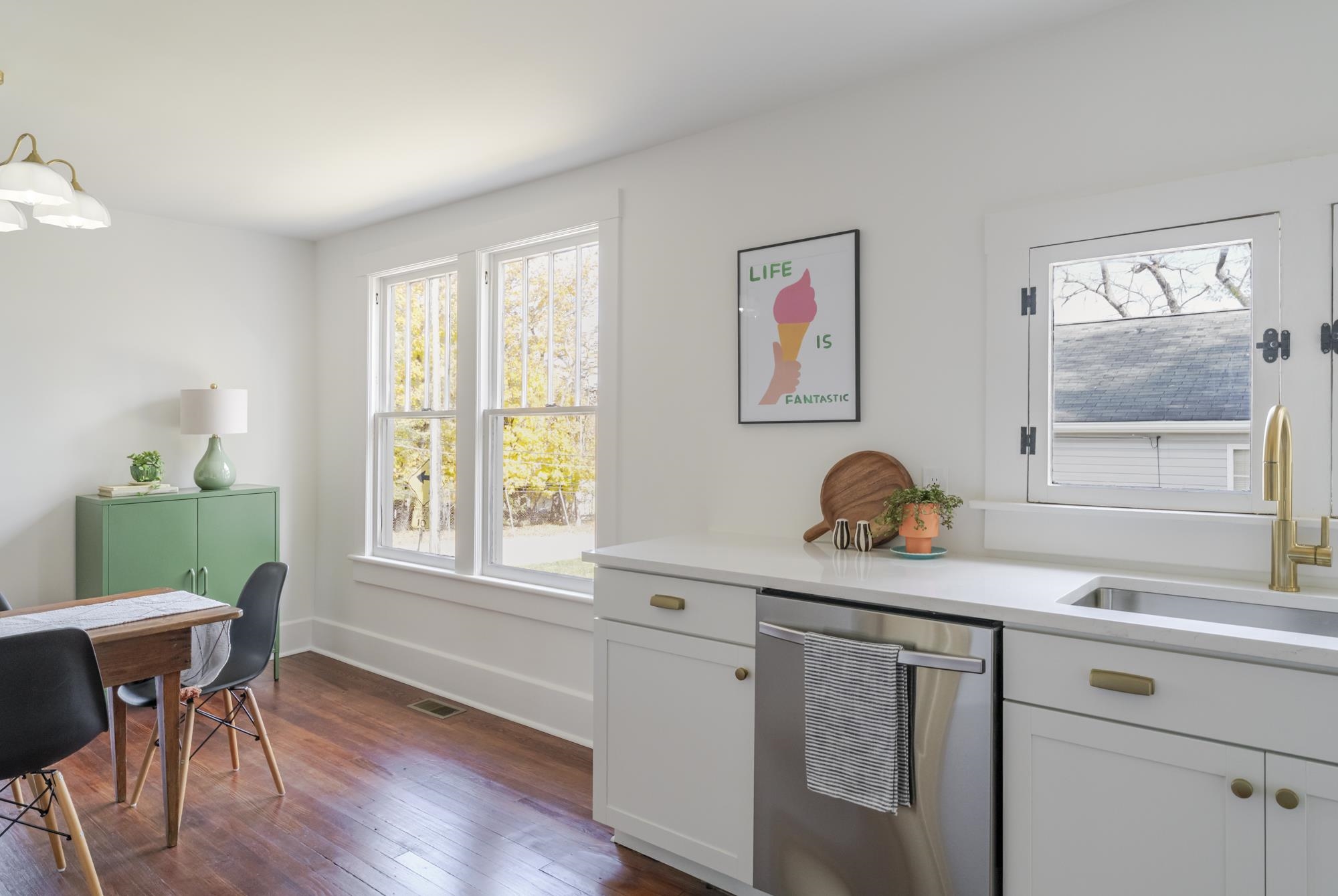 2216 Noon Street Staunton, VA 24401 - Photo 11 of 26 a kitchen with a table chairs a sink dishwasher window and cabinets