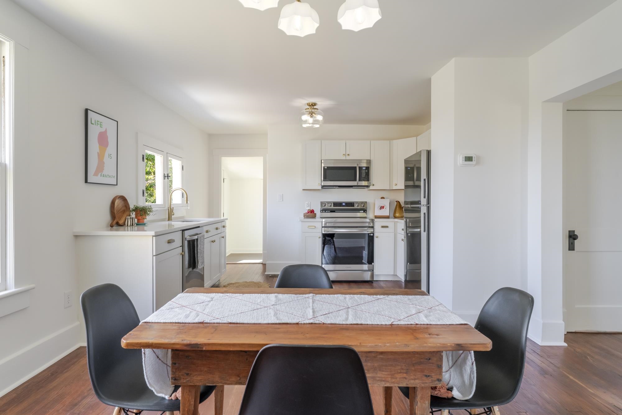 2216 Noon Street Staunton, VA 24401 - Photo 7 of 26 a kitchen with sink a microwave cabinets and chairs