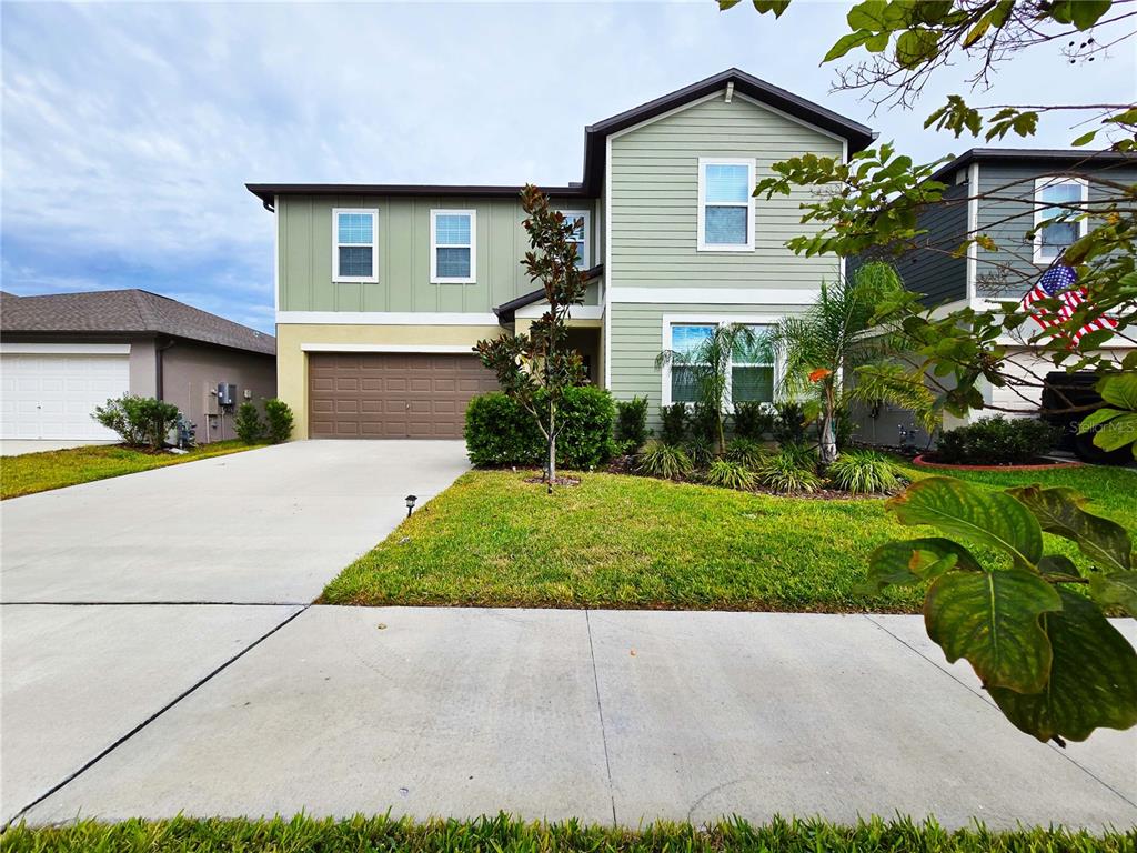 a front view of house with yard and green space