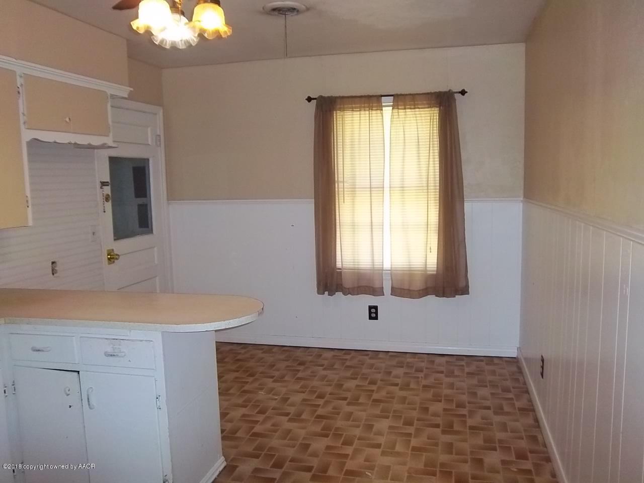 4309 Cline Road Amarillo, TX 79110 - Photo 5 of 16 a bathroom with a sink a mirror and a bathtub
