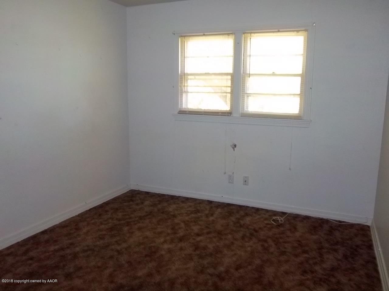 4309 Cline Road Amarillo, TX 79110 - Photo 9 of 16 an empty room with a window