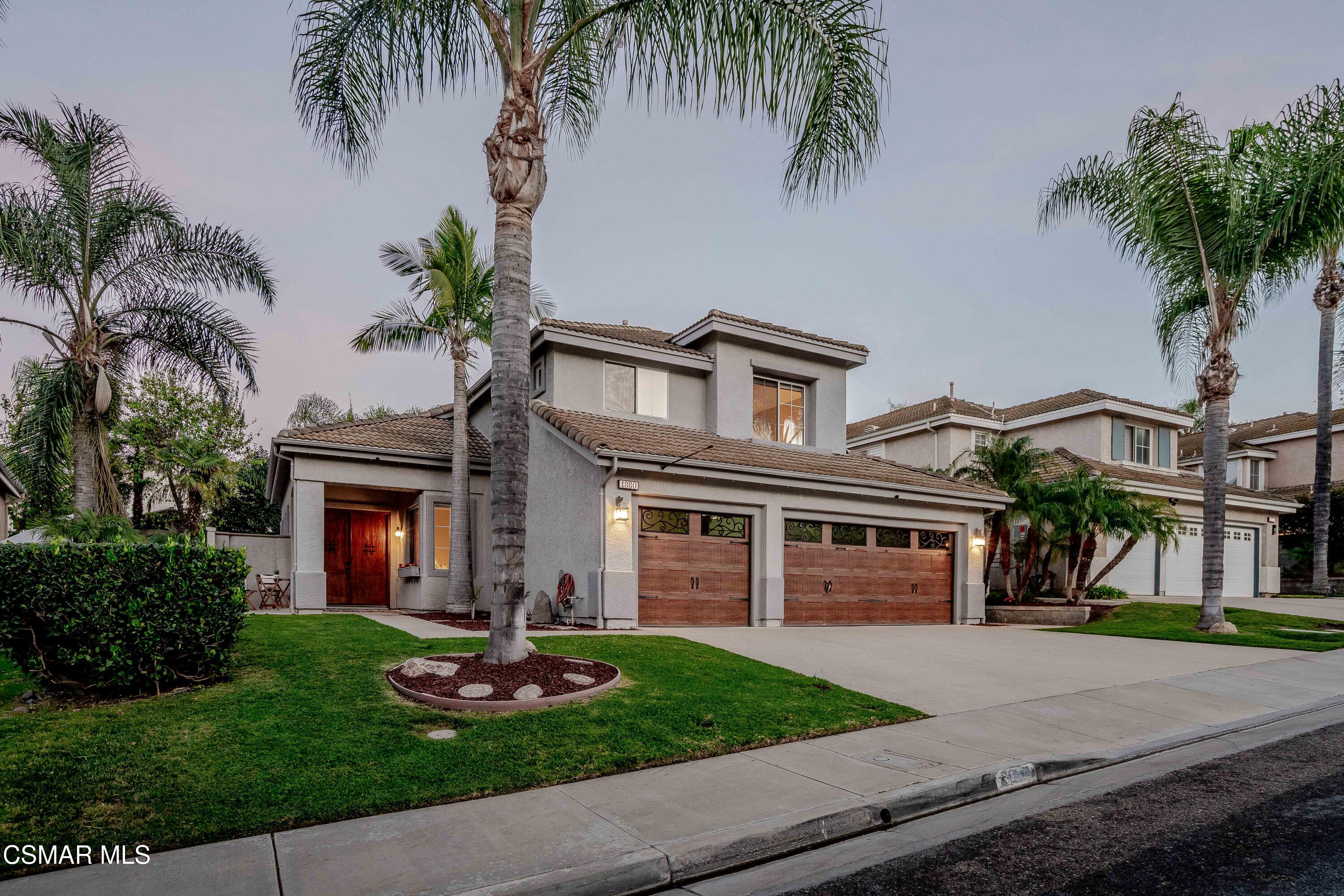 1880 Winterdew Avenue Simi Valley, CA 93065 - Photo 1 of 1 a front view of a house with a garden and yard