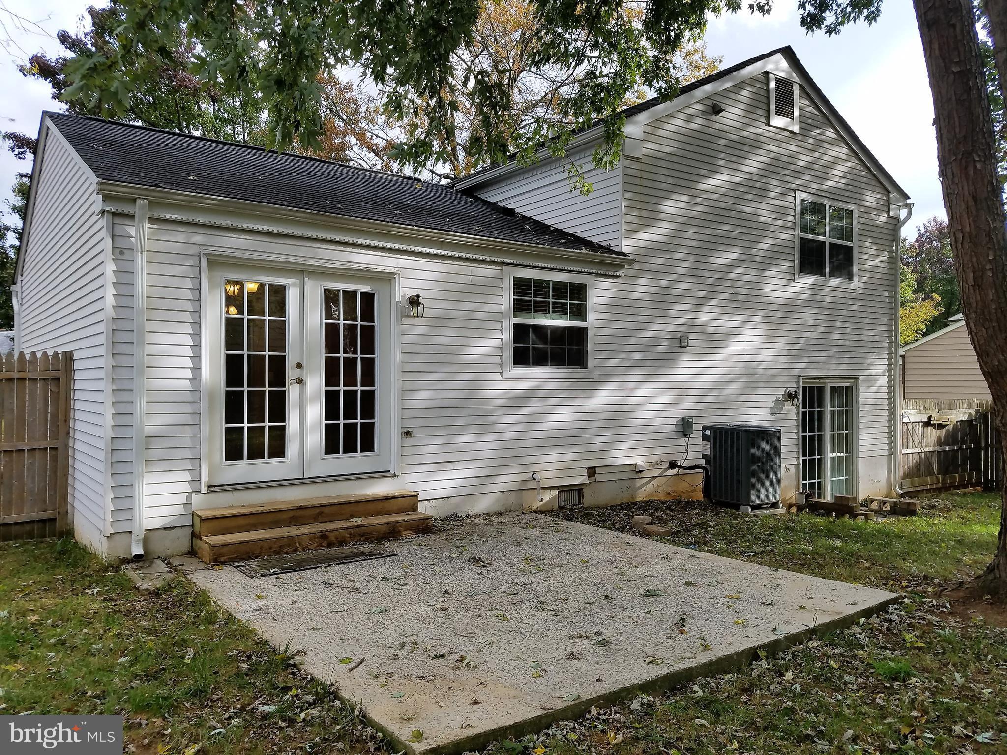 View of rear of house showing concrete patio