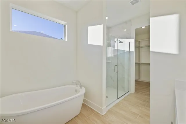 a bathroom with a bathtub and shower