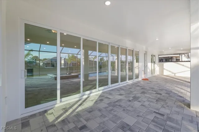 a view of backyard with tub and door