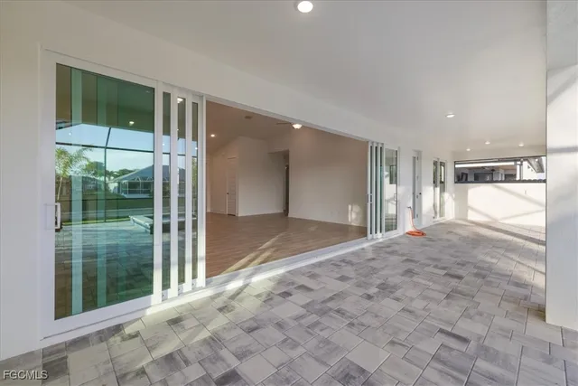 a view of a big room with windows and entryway