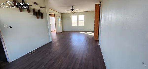 a view of a hallway with wooden floor and stairs