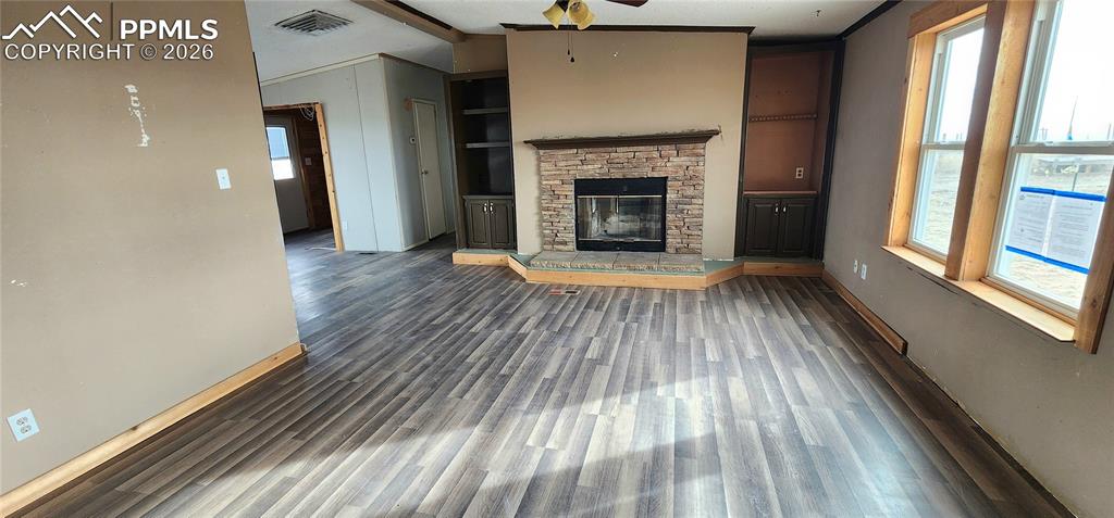 31995 North Neely Road Yoder, CO 80864 - Photo 13 of 21 a view of empty room with wooden floor and fireplace
