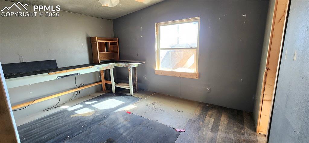 31995 North Neely Road Yoder, CO 80864 - Photo 9 of 21 a view of an empty room with wooden floor and a window