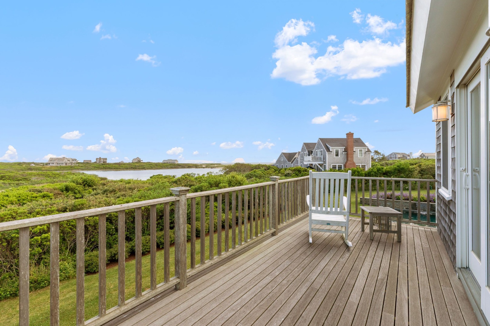 45 Starbuck Road Nantucket, MA 02554 - Photo 23 of 42 a view of a balcony with table and chairs and wooden floor
