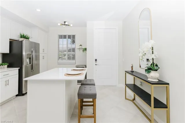 a room with furniture a sink and a refrigerator