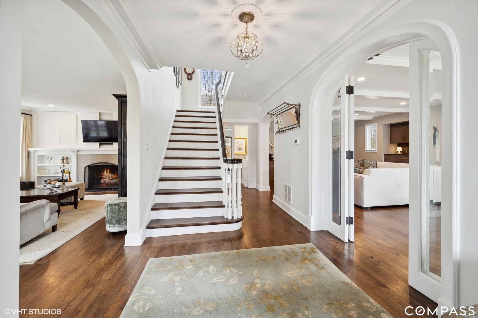 460 Berkeley Avenue Winnetka, IL 60093 - Photo 7 of 45 a view of a hallway with wooden floor fireplace and living room